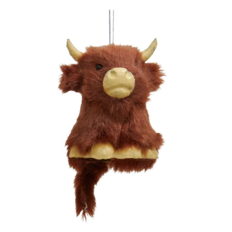 Dark brown fuzzy Highland cow ornament with curved horns, cream-colored muzzle and feet, and a hanging string.