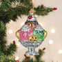 Decorative Christmas ornament shaped like a glass ice cream sundae with cookies on a Christmas tree.
