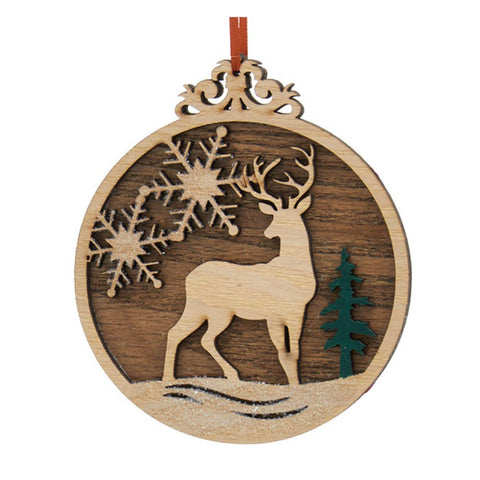 Round layered wood ornament with a standing deer, snowflake accents, evergreen tree, snowy base, and red ribbon hanger.