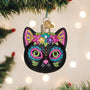 Decorative black cat ornament with colorful face on a Christmas tree.