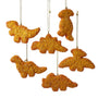 Six dinosaur chicken nugget ornaments in assorted shapes, including T-Rex, stegosaurus, long neck dinosaur, triceratops, and pterodactyl designs.