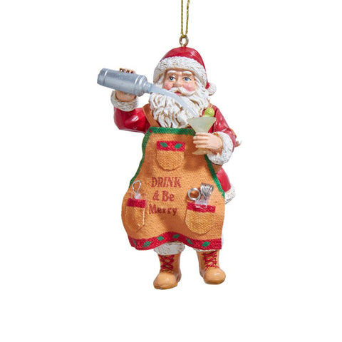 Santa ornament wearing a festive apron that reads Drink & Be Merry, holding a cocktail glass and pouring from a silver shaker.