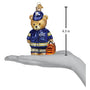 Teddy bear ornament in EMT uniform with measurement on a hand