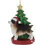 Dog Christmas ornament with a tree and star on a white background