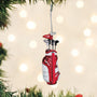 Golf bag ornament with clubs on a Christmas tree with lights in the background