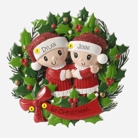 Christmas ornament with two people in red outfits standing in a wreath. Can be personalized.