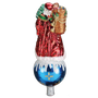 Back view of Father Christmas tree topper in a red robe with a basket on his back, standing on a blue ornament-style base.