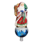 Father Christmas tree topper in a red robe holding a lantern and small tree, standing on a blue ornament-style base with snowy accents.