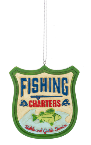 Shield-shaped fishing ornament with a green border, blue and red “Fishing Charters” lettering, and a green fish above “Tackle and Guide Service.”