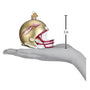 Gold and red Florida State football helmet ornament with measurement on a hand
