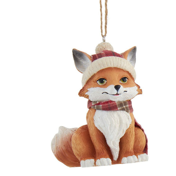 Fox ornament wearing a hat and scarf on a white background