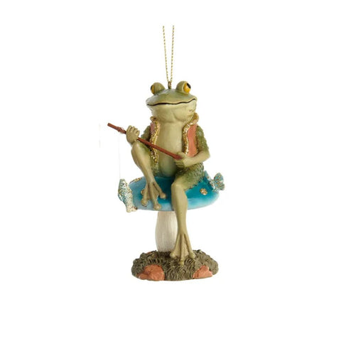 Frog ornament sitting on a blue mushroom and holding a fishing pole, with soft green tones and woodland details.