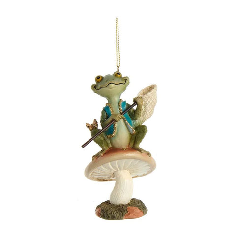 Frog ornament sitting on a mushroom and holding a net, with soft green tones, blue accents, and woodland-inspired details.