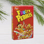 Fruity Pebbles cereal box Christmas ornament with cartoon characters on a white background