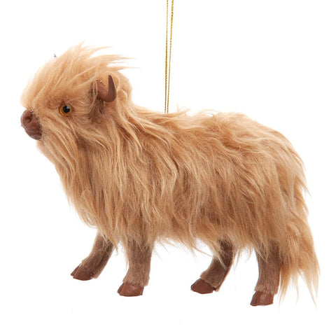Furry Highland cow ornament with a shaggy tan coat, small brown horns, and a fluffy tousled look.