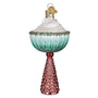 Decorative Martini glass with gingerbread man ornament with a pink base and blue top on a white background