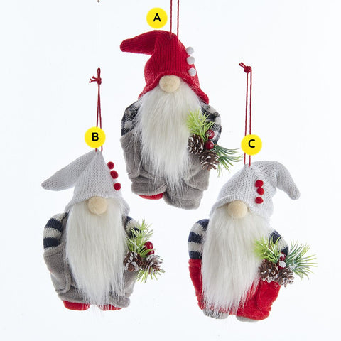 Three Christmas gnome ornaments with different colored hats on a white background