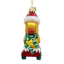 Front view of glass duck Christmas ornament with yellow duck, red Santa hat, green scarf, and red cart with snowy trim.