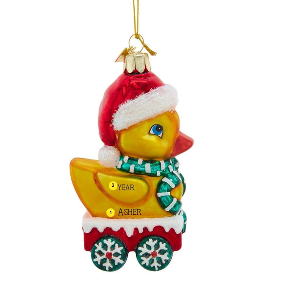 Personalized glass duck ornament with name and year placement shown on the yellow duck and red cart.
