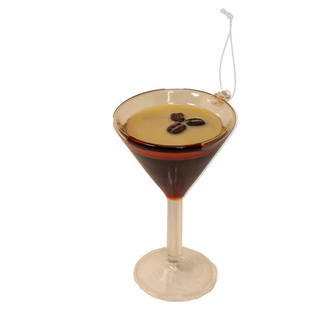 Glass ornament shaped like an espresso martini in a stemmed cocktail glass with a creamy top and three coffee beans.