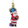 Glass Santa at the North Pole ornament with Santa holding a green gift beside a candy cane striped North Pole sign and purple present.