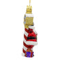 Side view of Santa at the North Pole glass ornament showing Santa in a red suit, striped pole, gold sign, and wrapped present.