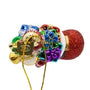 Top view of glass Santa boot ornament filled with bright wrapped gifts, candy cane accents, and gold ornament hanger.