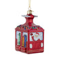 Front angle view of glass ski gondola ornament with Santa waving inside a red gondola decorated with skis, lights, and gold glitter trim.