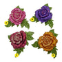Four glitter rose clip-on ornaments in pink, purple, burgundy, and gold with green glitter leaves and layered rose petals.