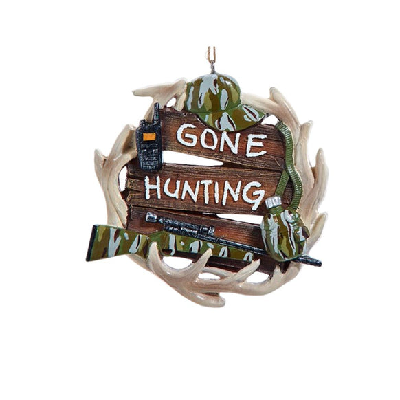 Hunting ornament with antlers, a wooden sign that reads “Gone Hunting,” camouflage accents, and a rifle detail hanging from twine.