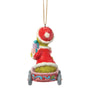 Back view of licensed Jim Shore Grinch in Wagon Ornament showing the Grinch in a Santa hat and red suit riding in a decorated holiday wagon.
