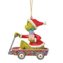 Side view of licensed Jim Shore Grinch in Wagon Ornament showing the Grinch in a red Santa suit with gifts and a pull wagon decorated with holly details.