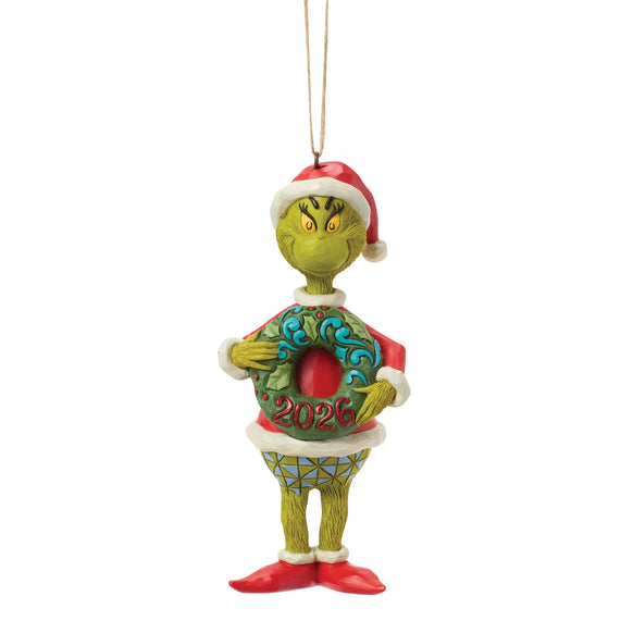 Front view of licensed Jim Shore Grinch with Dated 2026 Wreath Ornament featuring the Grinch holding a wreath with 2026 on the front.
