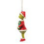 Side view of licensed Jim Shore Grinch with Dated 2026 Wreath Ornament showing the Grinch in Santa attire holding a festive wreath.
