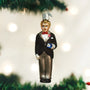 Christmas ornament of a man in a tuxedo with a top hat against a festive background.