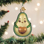 Avocado-shaped Christmas ornament with a heart on a decorated tree.