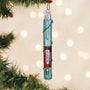 Decorative O'Santic pen ornament with a blue body and red label on a tree