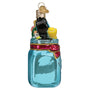 Decorative glass ornament of a mason jar with school items on a white background side view