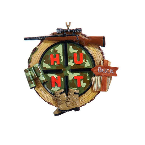 Round hunting ornament with camouflage sections spelling “HUNT,” plus binoculars, boots, a rifle, and a small sign reading “Buck.”