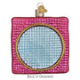 Decorative ornament with pink frame and gold detailing on a white background