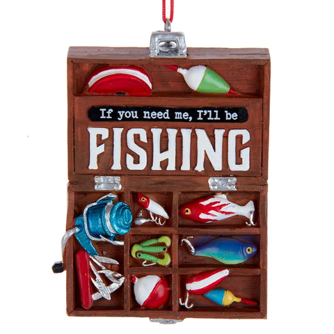Open brown tackle box ornament with fishing gear, lures, bobbers, a blue reel, and the message “If you need me, I’ll be fishing.”