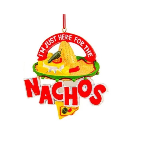 Nacho-themed ornament with a sombrero, colorful food accents, and the phrase “I’m Just Here for the Nachos,” hanging from a red cord.