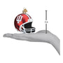 Red and white IU football helmet ornament with measurement on a hand