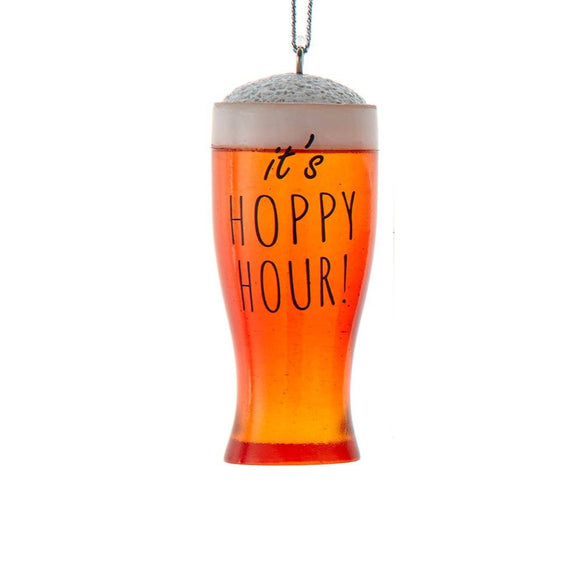 Ornament shaped like a frothy pint glass filled with amber beer and the words “It’s Hoppy Hour!”