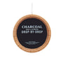 Jack Daniel’s barrel ornament with “Charcoal mellowed drop-by-drop” text on a black center.