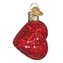 Red glittery ornament shaped like lips on a white background side view