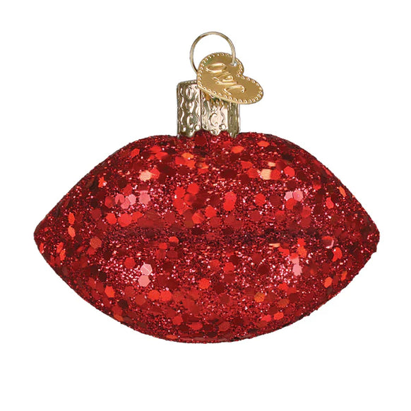 Red glittery ornament shaped like lips on a white background