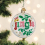Decorative Christmas ornament with 'Jingle' text on a tree with lights in the background