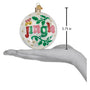 Christmas ornament with 'Jingle' text held in a hand for scale.