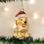 Christmas ornament of a dog wearing a Santa hat on a decorated tree.